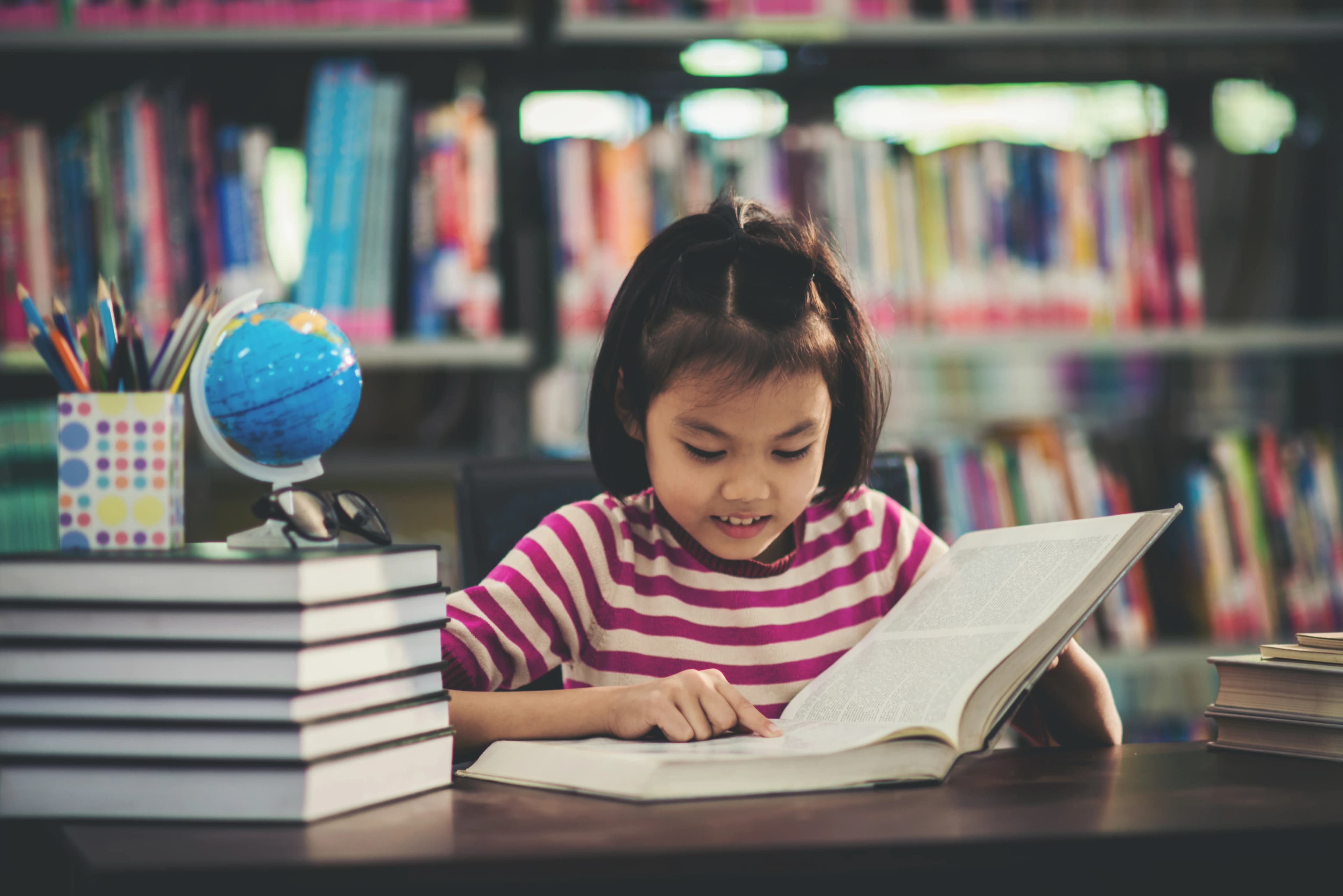Student child girl studying in library